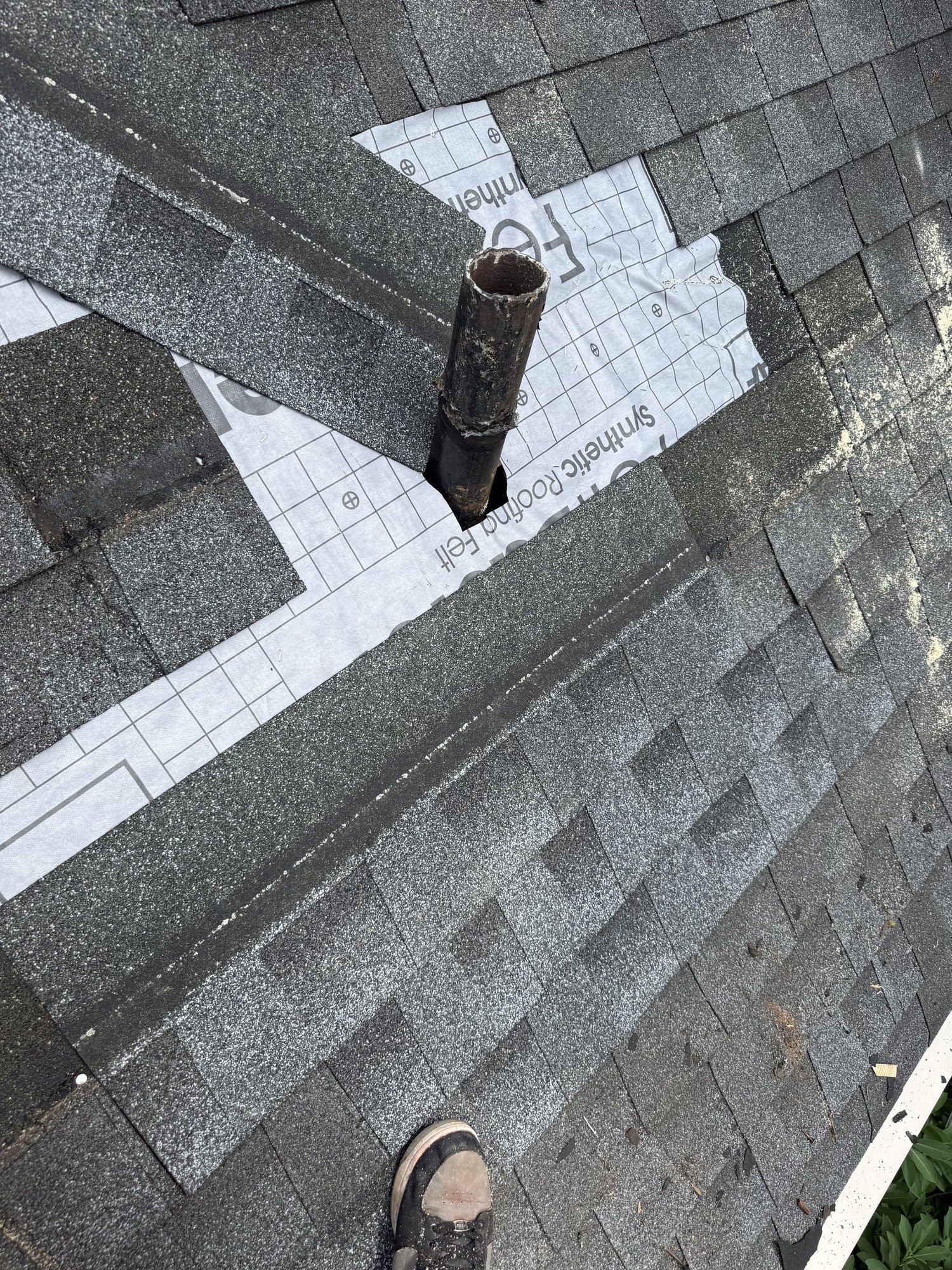 Plumbing vent pipe wrapped with ice and water shield before new shingles go back on